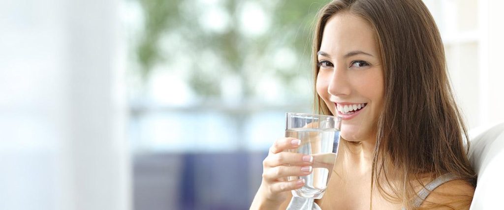 Pregnant women is drinking a water